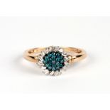 A 9ct gold cluster ring set with blue / green stones surrounded by baguette cut diamonds, approx