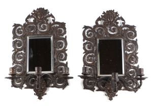 A pair of bronze mirror backed three-arm wall sconces, 27 by 44cms.