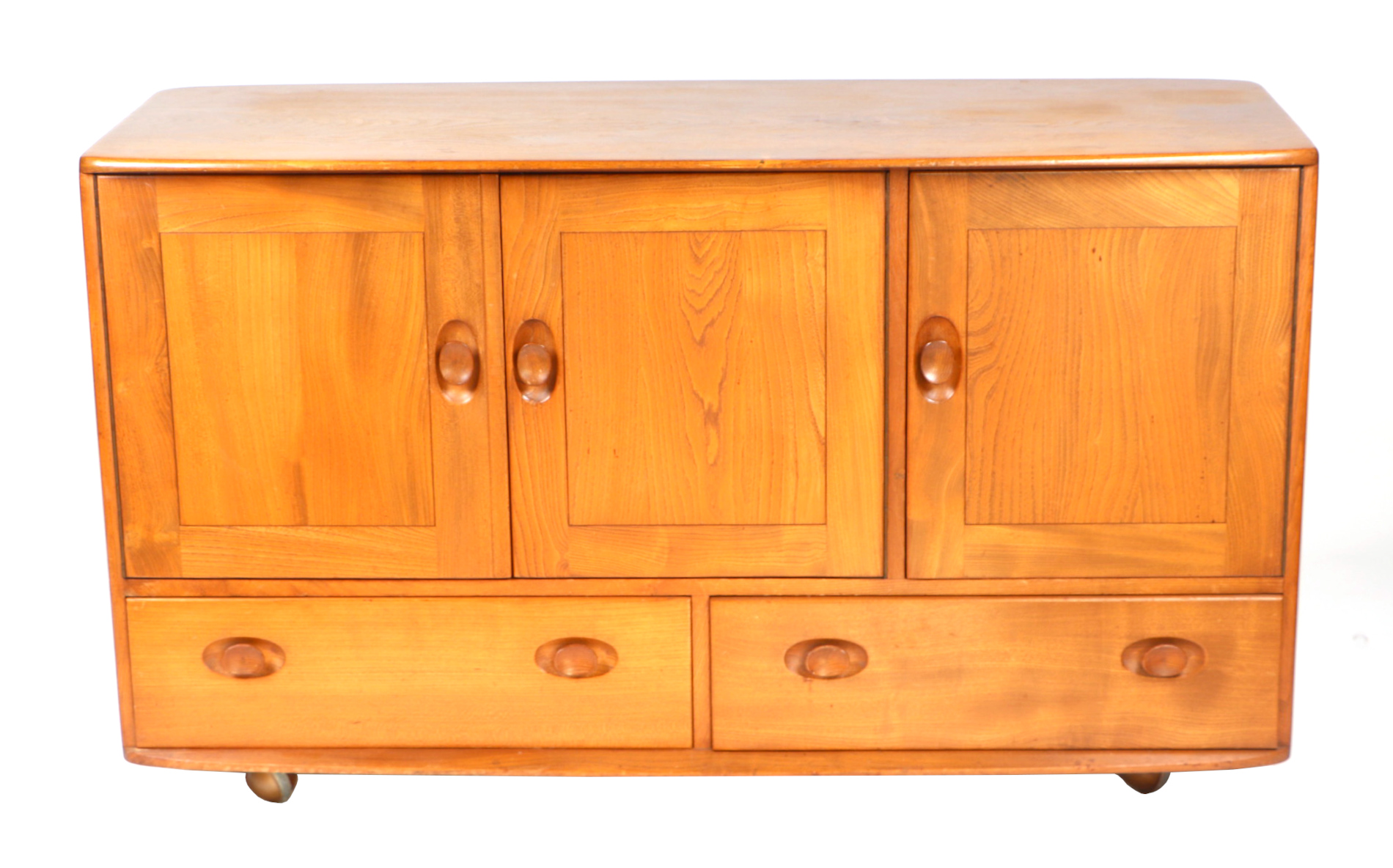 An Ercol sideboard with three cupboards above two long drawers, 131cms wide. Condition Report The