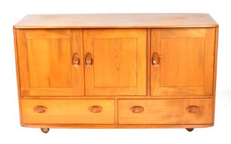 An Ercol sideboard with three cupboards above two long drawers, 131cms wide. Condition Report The