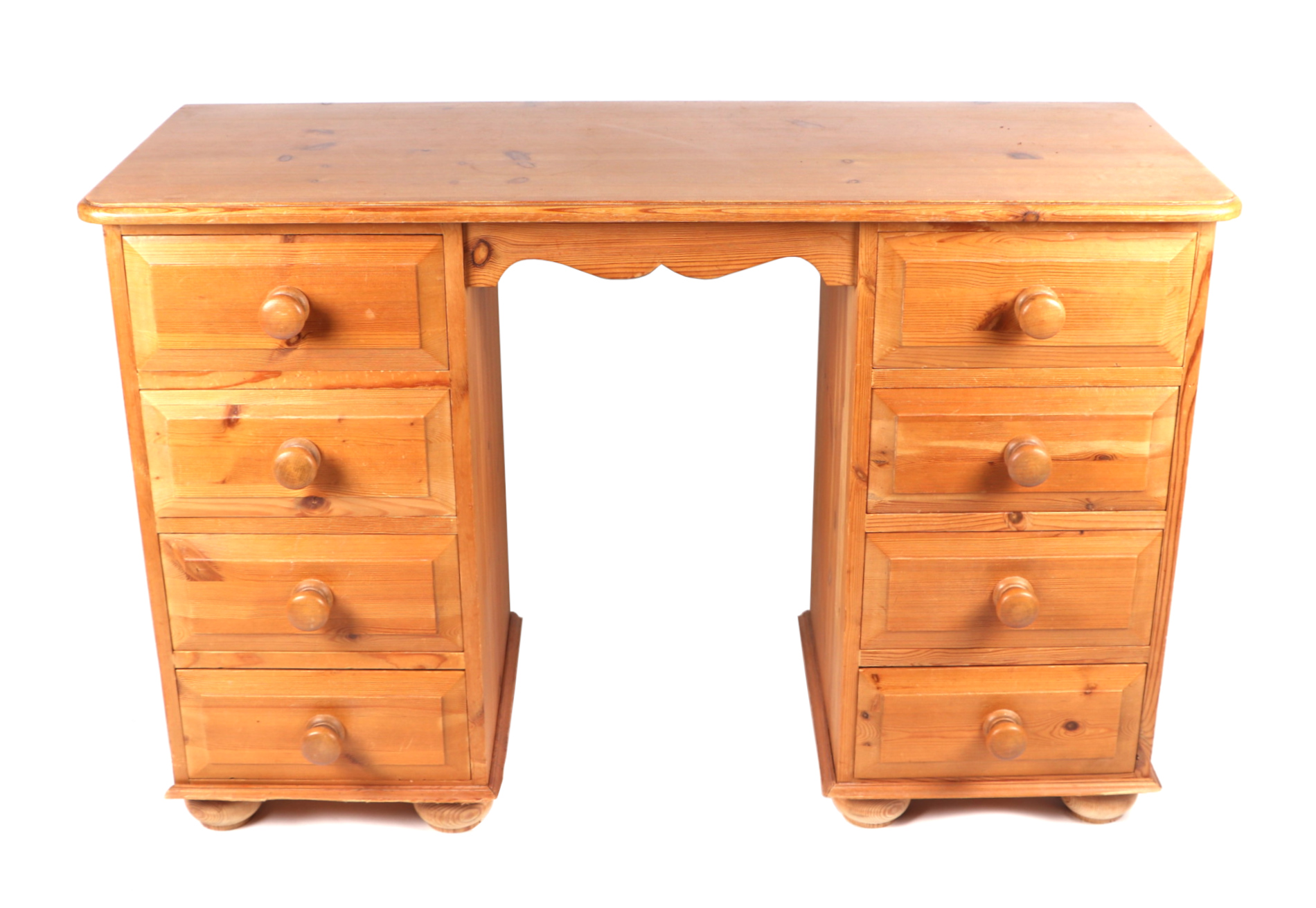 A modern pine pedestal desk with an arrangement of eight drawers, 114cms wide.