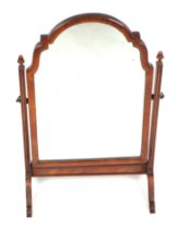 A Queen Anne style walnut toilet mirror with shaped rectangular plate, 38cms diameter.