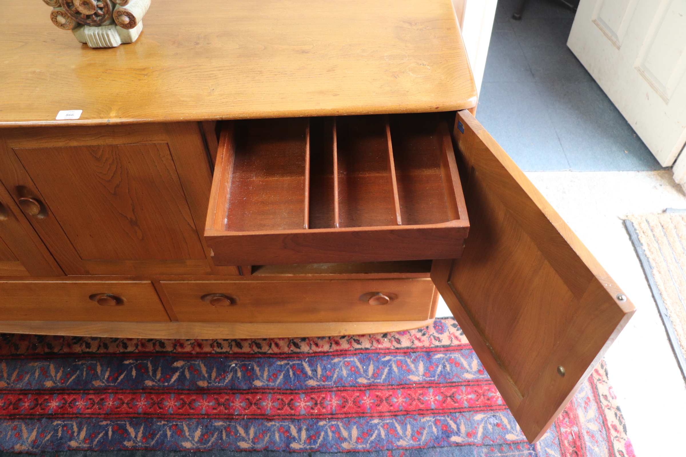 An Ercol sideboard with three cupboards above two long drawers, 131cms wide. Condition Report The - Image 7 of 9