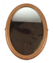 A Victorian style gilt gesso oval wall mirror, 85cms wide.