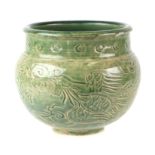 A Chinese green glazed vase with incised decoration, 11cms high.
