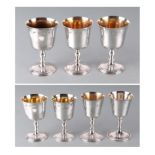 A matched set of seven mid century silver goblets with bell shaped bowls, knopped stems and