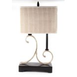 A modern French inspired table lamp with twin scroll support and ebonised base, 36cms wide.