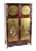 A Chinese black lacquered cabinet, the upper panelled doors with circular landscape scenes within