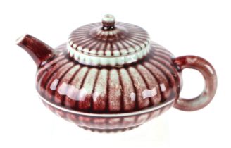 A Chinese teapot of compressed globular form with blue seal mark to the underside, 10cms high.