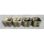 A set of four well weathered reconstituted stone lobed form planters, 32cms wide; together with a