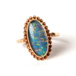 A 9ct gold dress ring set with a large oval opal, approx UK size 'N', 2.6g.