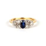 An 18tct gold, diamond and sapphire ring, the central sapphire flanked by six diamonds, approx UK