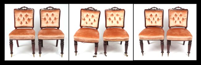 A set of six Victorian mahogany dining chairs with upholstered button backed backs, overstuffed