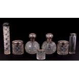 A pair of silver mounted cut glass scent bottles of globular form, 12cms high; together with five