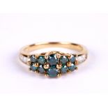 A 9ct gold dress ring set with ten green / blue stones and diamond set shoulders, approx UK size '
