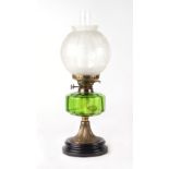 A Victorian oil lamp with green glass reservoir and etched glass shade, approx 54cms high.