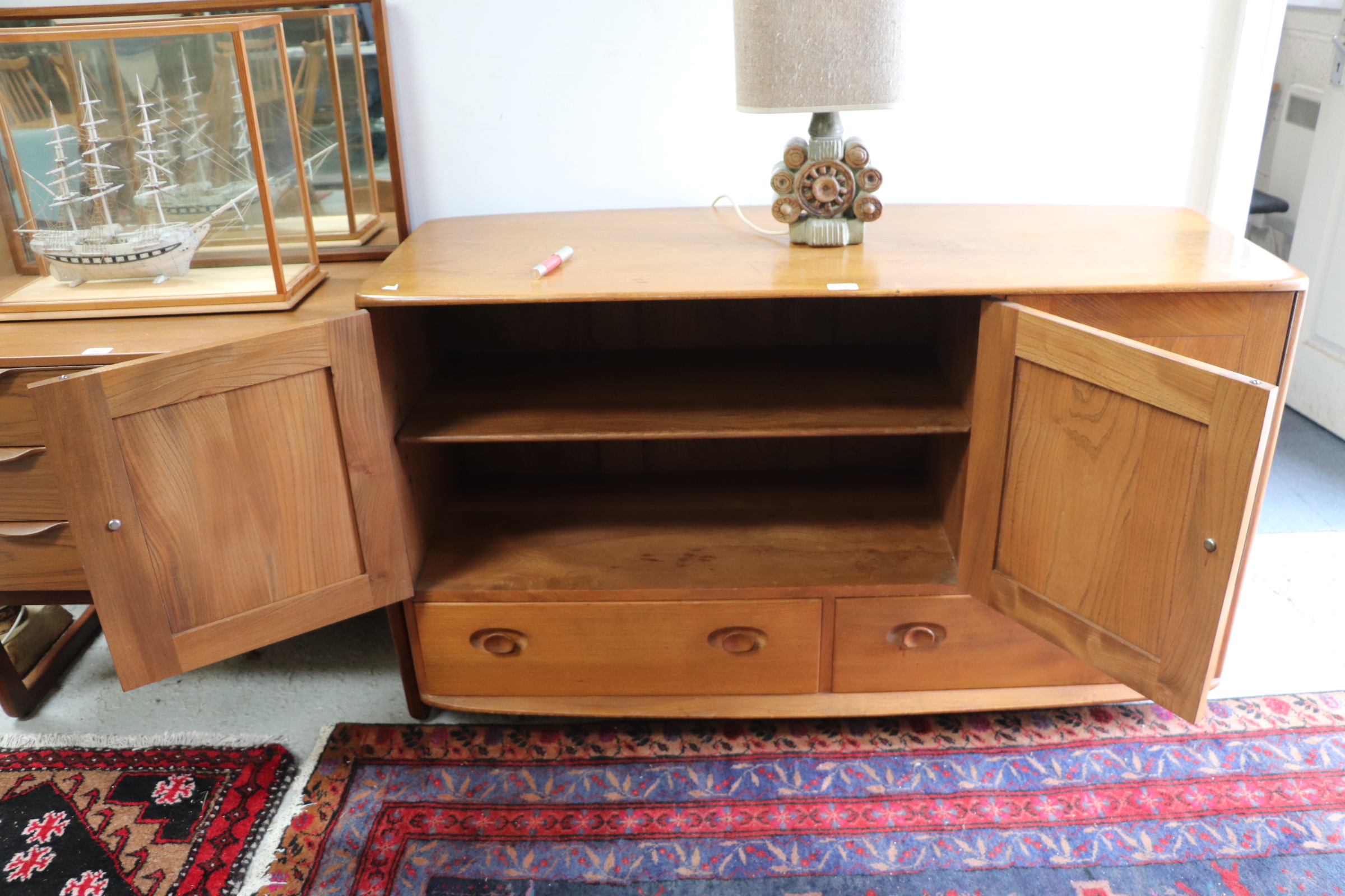 An Ercol sideboard with three cupboards above two long drawers, 131cms wide. Condition Report The - Image 6 of 9