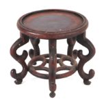 A Chinese hardwood vase stand with circular platform on scroll legs, 18cms diameter.