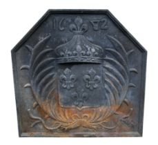 A 17th century style cast iron fire back with Fleur de Lys coat of arms, 60cms wide.