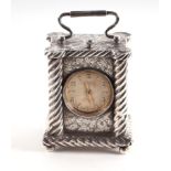 A Victorian silver miniature carriage clock, the panels with chased floral decoration and spiral