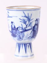 A Chinese blue & white stem cup decorated with figures in a landscape, 15.5cms high.