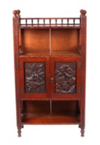 An Edwardian Arts & Crafts influenced oak bookcase with a three quarter galleried shelf above a