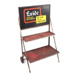 An original late 1960's / 70's Exide Batteries three-tier battery stand trolley.