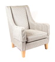 A modern Designer's Guild upholstered armchair on square tapering oak legs.