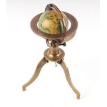 A 19th century style miniature table top terrestrial globe on a brass stand, 10cms wide.