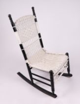 An ebonised and painted wickerwork rocking chair.