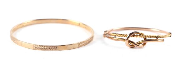 A 9ct gold knot twist bangle, 8g, cased; together with another 9ct gold bangle, 10g, cased (2).