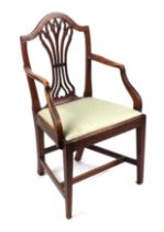 A Georgian mahogany elbow chair with upholstered drop-in seat, on square tapering front supports.