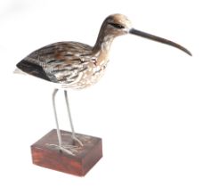 In the manner of Guy Taplin - a carved and painted wooden model of a wading bird, 32cms high.