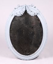A Victorian oval wall mirror (later painted), overall 57 by 71cms.