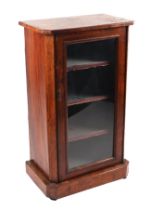 A Victorian rosewood side cabinet, the single glazed panelled door enclosing a shelved interior,