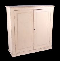 A Victorian painted pine cabinet, the twin panelled doors enclosing a shelved interior, on a