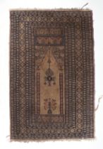 A small Persian prayer rug decorated with geometric design, on a cream ground, 69 by 128cms.