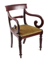 A William IV mahogany desk chair with scroll arms, drop-in seat and reeded and turned front legs.