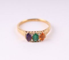 An 18ct gold dress ring set with coloured gem stones interspersed with diamonds, approx UK size 'P',
