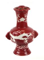 A Chinese vase decorated with dragons on a red ground, six character blue mark to the underside,