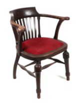 A Smoker's bow armchair with padded seat and turned front legs.