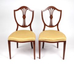 A pair of Edwardian Hepplewhite style occasional chairs with shield shaped backs, serpentine front