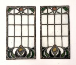 A pair of Art Nouveau design stained glass windows, 40 by 22cms; together with three stained glass