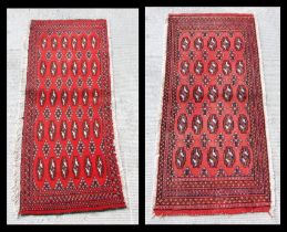 Two small Persian Turkoman woollen hand-made rugs with geometric designs on a red ground, each