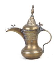 A Turkish / Islamic brass dallah coffee pot, 28cms high.