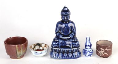 A Chinese blue glazed seated Buddha, 14cms high; together with a blue & white miniature double gourd