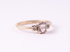 A 9ct gold ring set with a central pale pink stone and diamond set shoulders approx UK size 'L', 1.