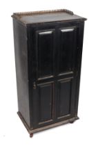 A Victorian ebonised side cabinet, the top with three-quarter pierced brass gallery above a panelled