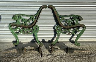 A pair of Coalbrookdale style cast iron bench ends with lion mask scroll arms; together with a