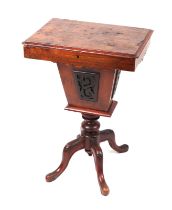 A Victorian walnut work table, the hinged lid opening to reveal a fitted interior, on a quatrefoil